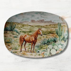 May include: A ceramic oval serving platter with a watercolor design of a brown horse standing in a desert landscape with cacti and mountains in the background.