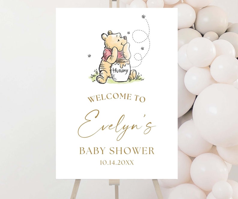 May include: A Winnie the Pooh themed baby shower welcome sign with a cartoon illustration of Winnie the Pooh holding a honey pot. The sign says "Welcome to Evelyn's Baby Shower 10.14.20XX".