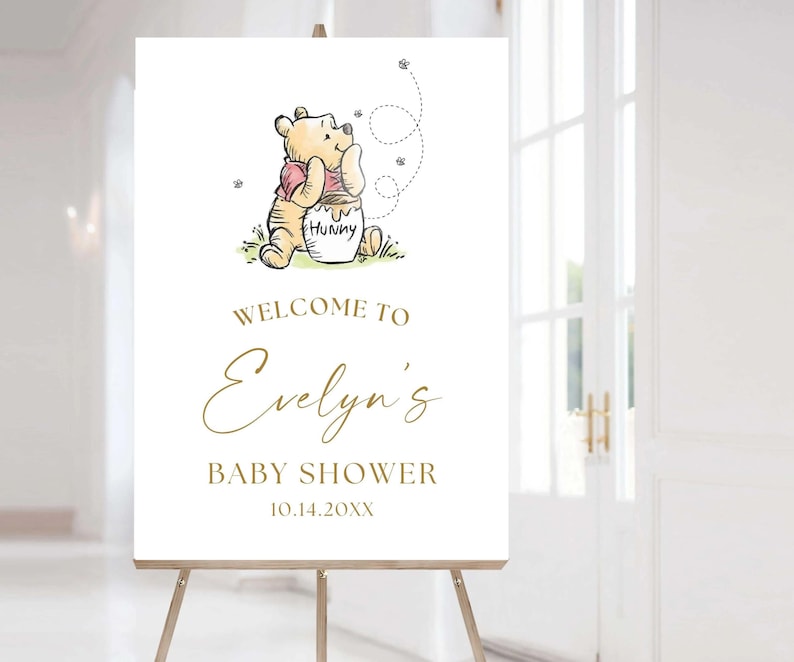 Greet your guests with this classic Bear Baby Shower welcome sign. Printed on sturdy foam board and mailed to you for added convenience. Gender neutral Baby girl or baby boy. Can be customized as a baby sprinkle or birthday poster with gold accents. Vintage Winnie Baby Shower Welcome Sign, Bear Poster, Gender Neutral Party Decor, Bear Baby Sprinkle, Storybook Hundred Acre Wood Decor.
This Classic Winnie Bear Baby Shower Welcome Sign adds a personalized touch to your upcoming event.