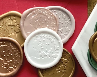 May include: Assortment of wax seals in various colors and designs, including gold, silver, red, and white. The seals feature intricate patterns and designs, such as snowflakes, trees, and geometric shapes.