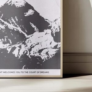 May include: A black and white illustration of a mountain range with the text "The City of Starlight Welcomes You to the Court of Dreams".
