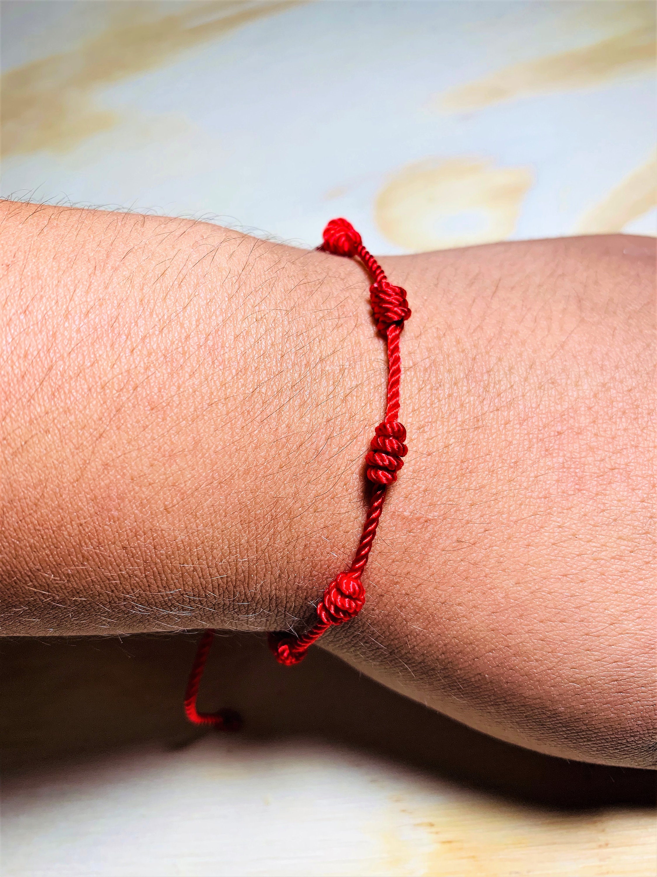 Red bracelet with 7 knots discount