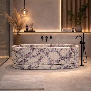 Peut inclure: Baignoire ovale avec un motif en marbre blanc et violet. La salle de bain comprend un robinet noir, un tapis de couleur neutre et des plantes décoratives. Les murs sont neutres et l'éclairage est chaleureux. La baignoire mesure environ 180 cm de long.