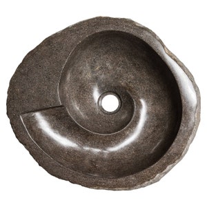 May include: A dark gray stone sink with a spiral design and a round drain hole. The sink is made of natural stone and has a rough, textured surface.
