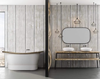 May include: A white freestanding bathtub with a gold rim sits in a bathroom with wood paneling and a double vanity with two sinks. The vanity has a wooden top and black metal legs. There are several black caged pendant lights hanging from the ceiling.