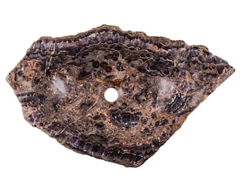 May include: A purple and brown stone sink with a round hole in the center. The sink is made of natural stone and has a unique, organic shape.