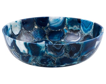 May include: A large, round bowl made of blue agate. The bowl is made of many small pieces of agate that have been glued together to create a mosaic pattern. The bowl is perfect for serving snacks or fruit.