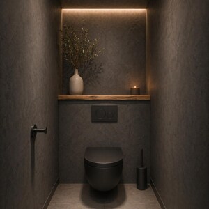 May include: A modern, minimalist bathroom interior with a black toilet, flush plate, and accessories. A wooden shelf holds a vase with greenery and a lit candle. The walls are dark gray with a textured finish, and the space is illuminated by warm lighting.