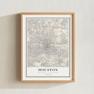 May include: A framed map print of Houston, Texas, featuring a detailed street grid in black lines against a light beige background. The text HOUSTON, the coordinates 29°45'46"N / 95°22'59"W, and TEXAS are printed in black at the bottom of the map.