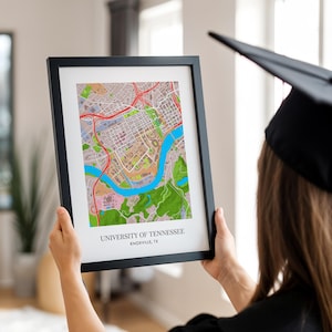 May include: A framed map print of the University of Tennessee campus in Knoxville, Tennessee. The map is in a black frame and shows the campus buildings, roads, and surrounding area.