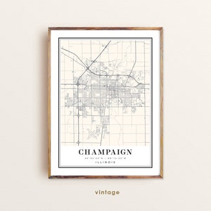 May include: A vintage map print of Champaign, Illinois. The map shows the city streets and landmarks in black and white. The text "Champaign, Illinois 40°06'54"N / 88°14'32"W vintage" is printed at the bottom of the map.