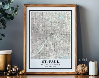 May include: Framed map print of St. Paul, Minnesota, in a neutral colour palette. The map features the city's layout with roads and waterways. The print is labelled "St. Paul" with coordinates and "Minnesota" below. The frame is light brown.