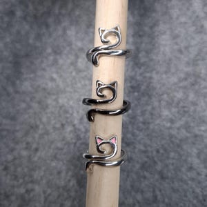 Könnte beinhalten: Ein Set aus drei Keramikbechern mit gesprenkelter, matter Oberfläche. Die Becher sind in den Farbtönen Creme, Hellgrau und Dunkelgrau gehalten. Jeder Becher hat ein schlichtes, minimalistisches Design, ideal für Kaffee oder Tee.