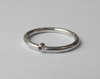 Silver stacking ring with small round garnet