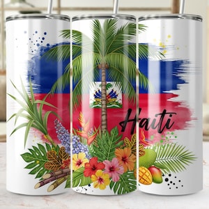 May include: A white tumbler featuring the Haitian flag design with a palm tree, tropical flowers, and the word "Haiti." The design includes red, blue, and white colors, with accents of green, yellow, and pink.