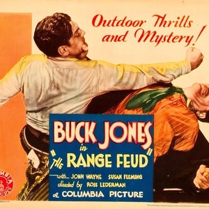 May include: A vintage movie poster for the Western film "Buck Jones in the Range Feud". The poster features a scene of two men fighting, with the title text in large, bold letters. The poster also includes the names of the actors, John Wayne and Susan Fleming, and the director, Ross Lederman.