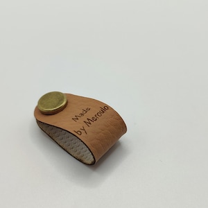 Custom riveted labels,threaded rivets tags,center fold labels with rivets,faux leather labels,faux leather tags,folding tags,rivet on labels