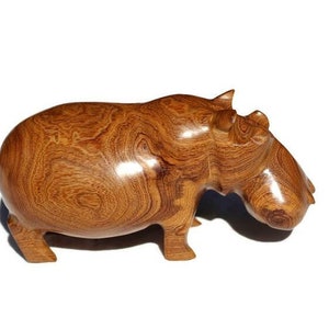 Mubanga Wood Handcarved Hippo figurine. Zambian Kiaat Smooth wooden Safari sculptures. Unique wood grain on a light brown hardwood piece.