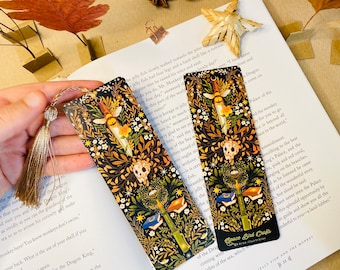May include: Two gold and black bookmarks with a floral design and a skull. The bookmarks feature a dagger, a bee, and a book. The text on the bookmark reads "Space Bird Crafts".