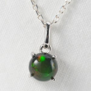 Natural black opal necklace in cabochon on silver pendant.