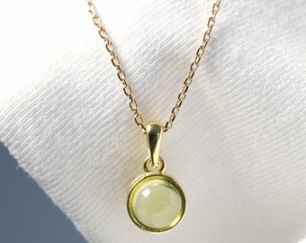 Natural Peridot necklace with golden pendant and cabochon.