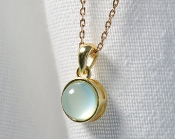 necklace with a gold pendant and an aqua chalcedony.