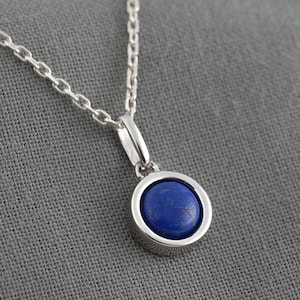 Necklace with a natural Lapis lazuli stone in cabochon and a pendant and a silver chain. Small minimalist jewel for women.