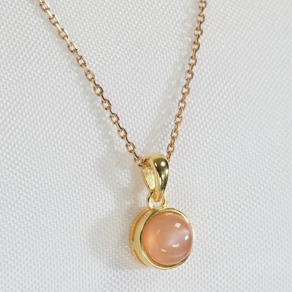 Natural peach moonstone necklace in cabochon with golden pendant and chain, jewelry for women.