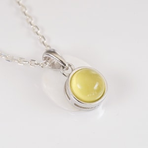 Natural yellow chalcedony cabochon necklace with minimalist pendant and silver chain. Bright and natural summer jewelry.