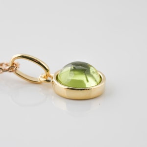 Natural Peridot necklace with golden pendant and cabochon.