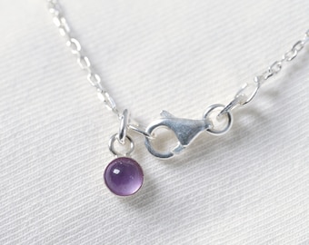 Minimalist necklace with 4mm amethyst cabochon and silver pendant.