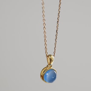 Necklace with a natural blue chalcedony, pendant and golden chain, blue cabochon stone for women.