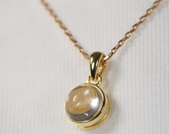 Natural rock crystal (quartz) necklace in cabochon with chain and gold pendant. Minimalist jewelry for women.