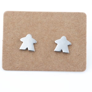 silver meeple earrings, minimalist jewel with the silhouette of board game pawns.