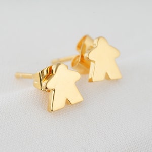 golden meeple earrings, minimalist jewel with the silhouette of board game pawns.