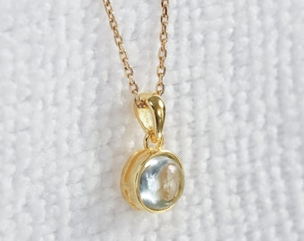 Natural aquamarine cabochon necklace with pendant and gold chain, minimalist jewelry with blue stone for a unique gift.