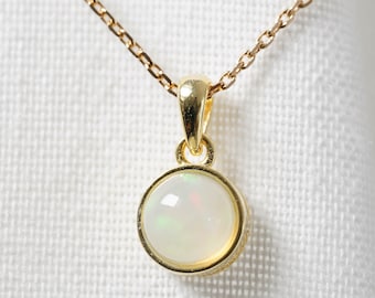 Golden natural opal necklace with a small minimalist pendant