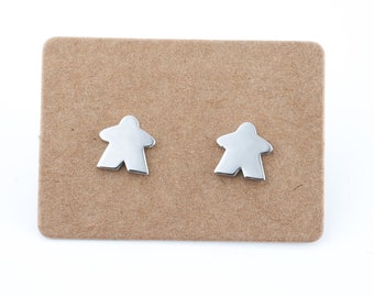 silver meeple earrings, minimalist jewel with the silhouette of board game pawns.