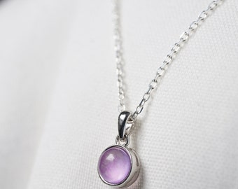 Necklace with a natural Lapis lazuli stone in cabochon and a pendant and a silver chain. Small minimalist jewel for women.