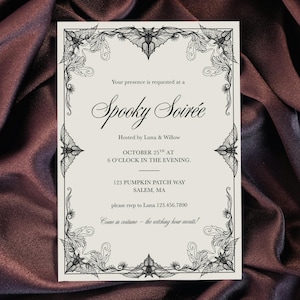 May include: A Halloween-themed invitation with a black and white decorative border featuring bats and floral elements. The invitation reads "Spooky Soirée" and includes event details such as the date, time, location, and RSVP information.