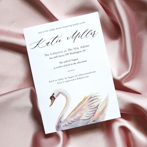 May include: A white baby shower invitation with a watercolor illustration of a swan. The invitation reads "Join us for a baby shower honoring mother-to-be Katie Miller. The Lafayette at The Hay Adams 800 16th Street NW Washington, DC. The 20th of August at twelve o'clock in the afternoon. RSVP to Ashley by August 5th ashleyza@mail.com, Katie is registered at Babylist.com."