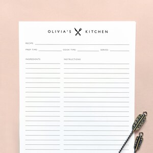 Op de afbeelding: Een witte, printbare receptenkaart met de titel "Olivia's Kitchen" en ruimte voor de naam van het recept, de voorbereidingstijd, de kooktijd, de porties, de ingrediënten en de instructies.