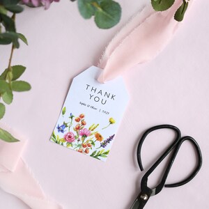 May include: White thank you tag with a floral design and the text "THANK YOU" in black. Below the text is "Sophie & Oliver | 5.9.23" in black.