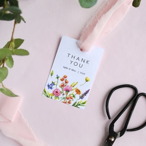 May include: White thank you card with a floral design and the text "Thank You" in black. The card also includes the text "Sophie & Oliver | 5.9.23".