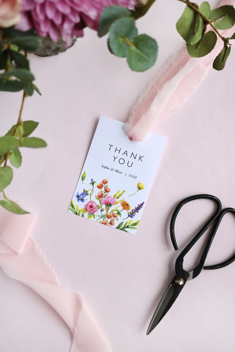 May include: White thank you card with a floral design and the text "Thank You" in black. The card also includes the text "Sophie & Oliver | 5.9.23".