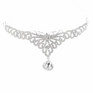 May include: A silver and crystal bridal headband with a delicate, floral design and a large, teardrop-shaped crystal pendant.