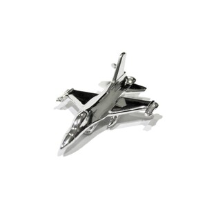 May include: A silver model of a fighter jet with a sleek design. The model is detailed with sharp angles and a pointed nose.
