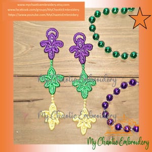 May include: Embroidered purple, green, and yellow earrings with a fleur-de-lis design. The earrings are displayed with green and purple beaded necklaces. The text "My Chaotic Embroidery" is visible.