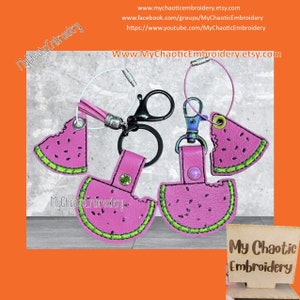 May include: Three pink watermelon-shaped keychains with green outlines and black seed details. The keychains are attached to silver key rings with a black and silver split ring. The keychains are on a bright orange background with the text "My Chaotic Embroidery" in white.