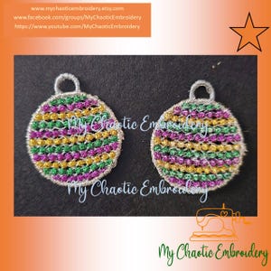 May include: Two round, embroidered ornaments with a silver metallic thread border. The ornaments are decorated with alternating stripes of green, gold, and purple thread. The ornaments have a silver loop at the top.